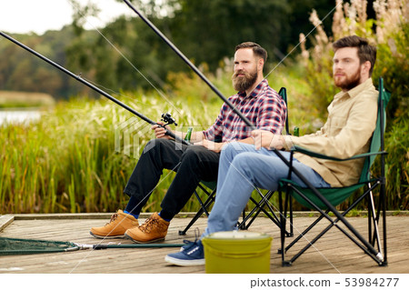 friends with fishing rods at lake or river friends with fishing rods at lake or river 53984277