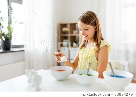 girl coloring easter eggs by liquid dye at home girl coloring easter eggs by liquid dye at home 53984279