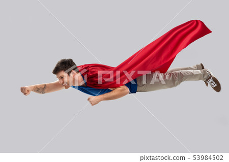 man in red superhero cape flying in air 53984502