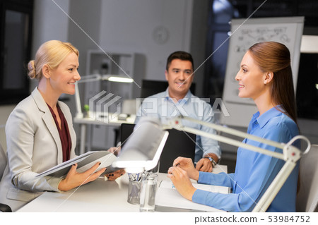 business team with laptop working late at office business team with laptop working late at office 53984752