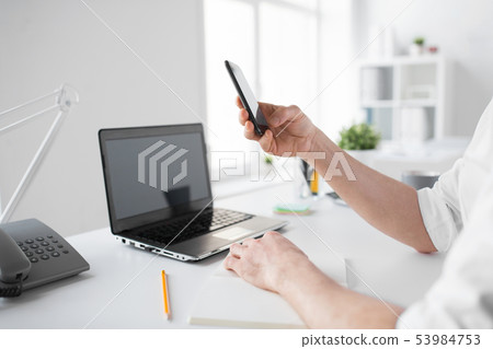 businessman using smartphone at office businessman using smartphone at office 53984753