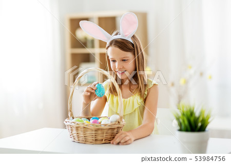 happy girl with colored easter eggs at home happy girl with colored easter eggs at home 53984756