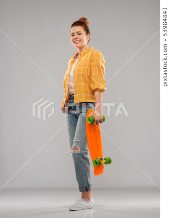 red haired teenage girl with short skateboard 53984841