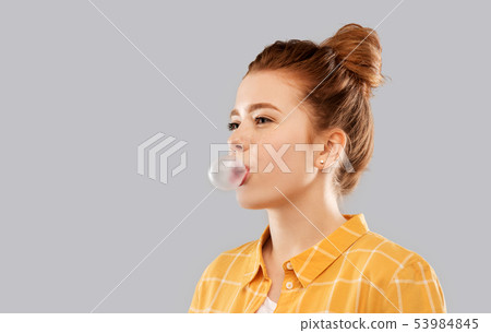 red haired teenage girl blowing bubble gum red haired teenage girl blowing bubble gum 53984845