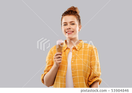 happy red haired teenage girl with ice cream cone happy red haired teenage girl with ice cream cone 53984846