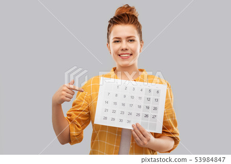 happy red haired teenage girl with calendar sheet 53984847