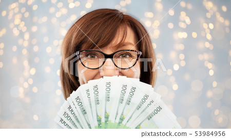 senior woman with hundreds of euro money banknotes senior woman with hundreds of euro money banknotes 53984956