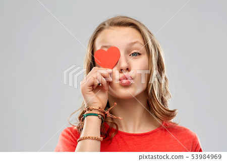 teenage girl covering eye with red heart 53984969