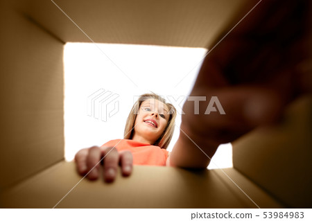 happy girl taking something out of open gift box happy girl taking something out of open gift box 53984983