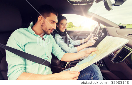 happy man and woman with road map driving in car happy man and woman with road map driving in car 53985148