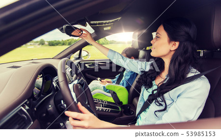 happy woman with little child driving in car happy woman with little child driving in car 53985153