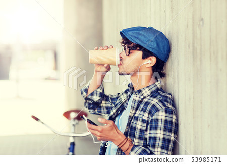 man with earphones and smartphone drinking coffee man with earphones and smartphone drinking coffee 53985171