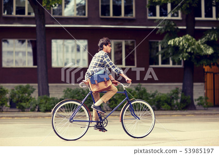 young hipster man with bag riding fixed gear bike 53985197
