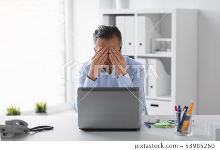 stressed businessman with laptop working at office stressed businessman with laptop working at office 53985260
