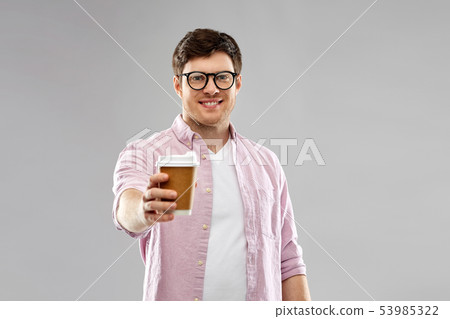 young man or student in glasses drinking coffee young man or student in glasses drinking coffee 53985322
