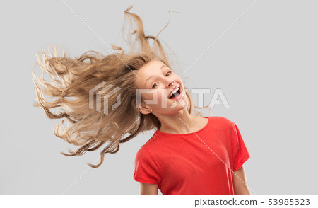 smiling teenage girl in red with long wavy hair smiling teenage girl in red with long wavy hair 53985323