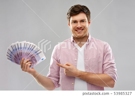 smiling young man showing fan of euro money smiling young man showing fan of euro money 53985327