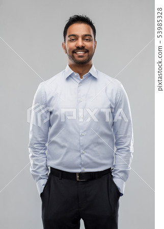 indian businessman in shirt over grey background indian businessman in shirt over grey background 53985328