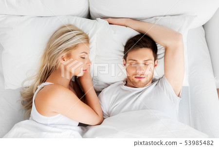 happy couple sleeping in bed at home happy couple sleeping in bed at home 53985482