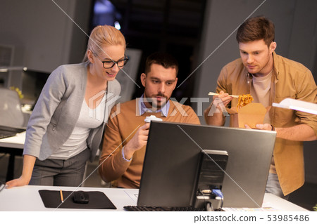 business team with computer working late at office business team with computer working late at office 53985486