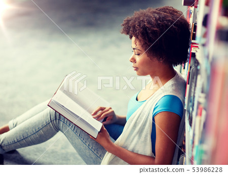 african student girl reading book at library 53986228