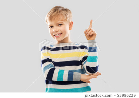 little boy in striped pullover pointing finger up little boy in striped pullover pointing finger up 53986229