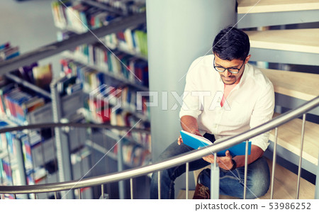 hindu student boy or man reading book at library hindu student boy or man reading book at library 53986252