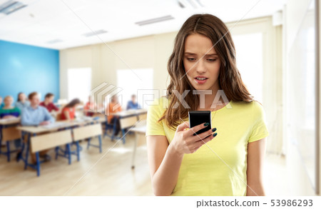 teenage student girl using smartphone at school 53986293
