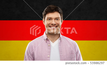 Smiling Young Man Over German Flag Colors Stock Photo