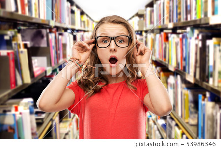 surprised student girl in glasses at library surprised student girl in glasses at library 53986346