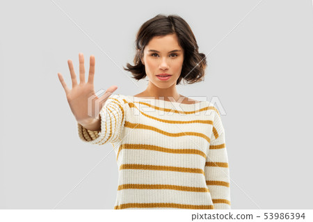 young woman making stopping gesture young woman making stopping gesture 53986394