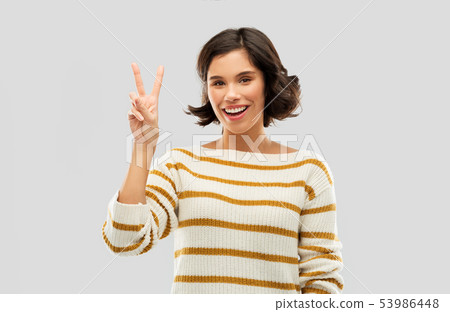 happy smiling woman showing peace or two fingers happy smiling woman showing peace or two fingers 53986448