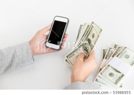 close up of hands with smartphone and dollar money close up of hands with smartphone and dollar money 53986955