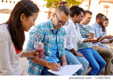group of happy students with notebook and drinks 53987003