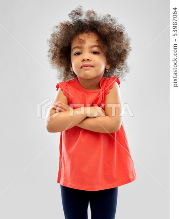displeased little african american girl over grey 53987064