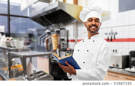 happy indian chef with cookbook at kebab shop happy indian chef with cookbook at kebab shop 53987195