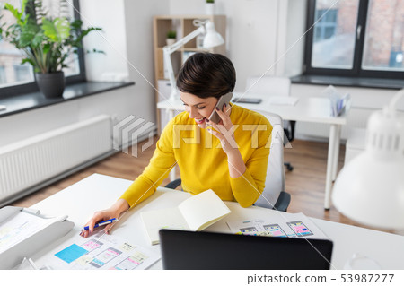happy ui designer calling on smartphone at office happy ui designer calling on smartphone at office 53987277