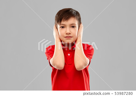 boy in red t-shirt closing ears by hands boy in red t-shirt closing ears by hands 53987280