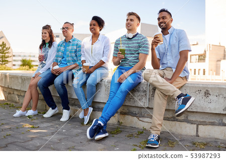 friends drinking coffee and juice talking in city 53987293