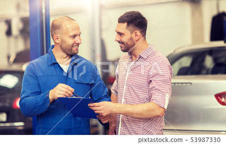 auto mechanic with clipboard and man at car shop 53987330