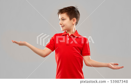smiling boy holding something on empty hands smiling boy holding something on empty hands 53987348