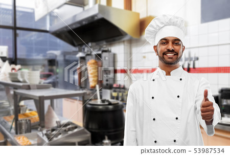 happy indian chef showing thumbs up at kebab shop happy indian chef showing thumbs up at kebab shop 53987534