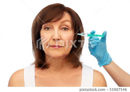 senior woman and surgeon hand with syringe senior woman and surgeon hand with syringe 53987546