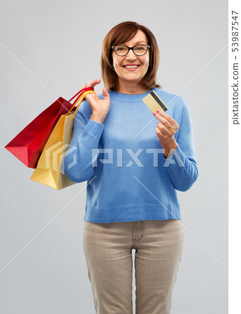 senior woman with shopping bags and credit card senior woman with shopping bags and credit card 53987547