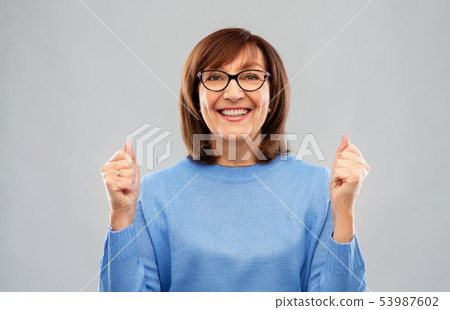 portrait of happy senior woman celebrating triumph portrait of happy senior woman celebrating triumph 53987602