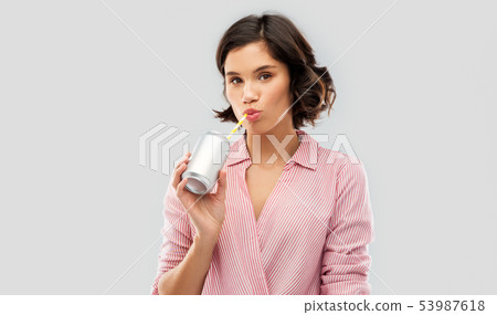 woman drinking soda from can with paper straw 53987618
