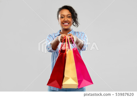 happy african american woman with shopping bags 53987620
