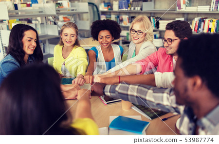 group of international students making fist bump 53987774
