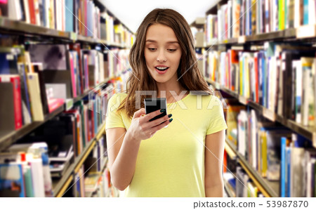 teenage student girl using smartphone at library teenage student girl using smartphone at library 53987870