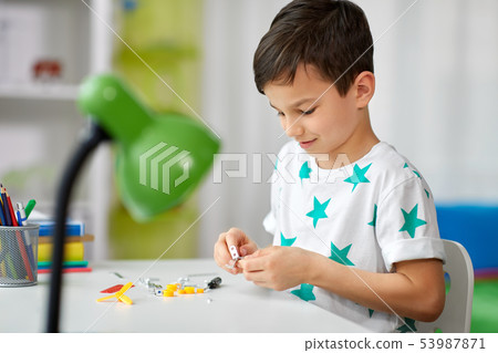 little boy playing with building kit at home little boy playing with building kit at home 53987871